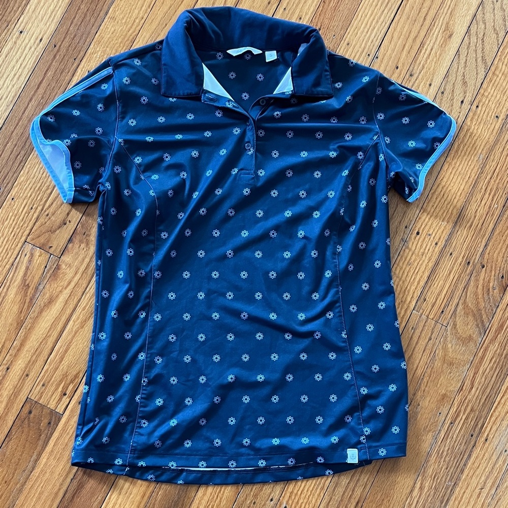 Womens navy blue polo shirt with light blue trim and pattern